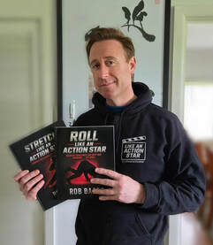 Rob Baard holding the Roll Like an Action Star books